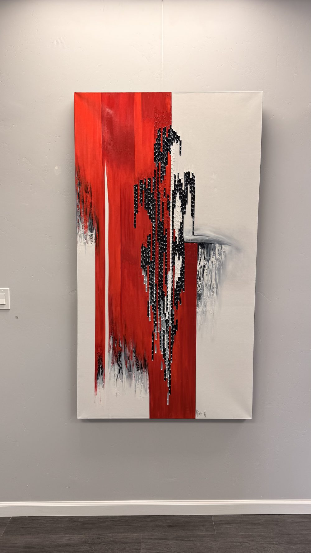 Large-scale red and black abstract expressionist oil painting by Nina K at the Sedona Showroom